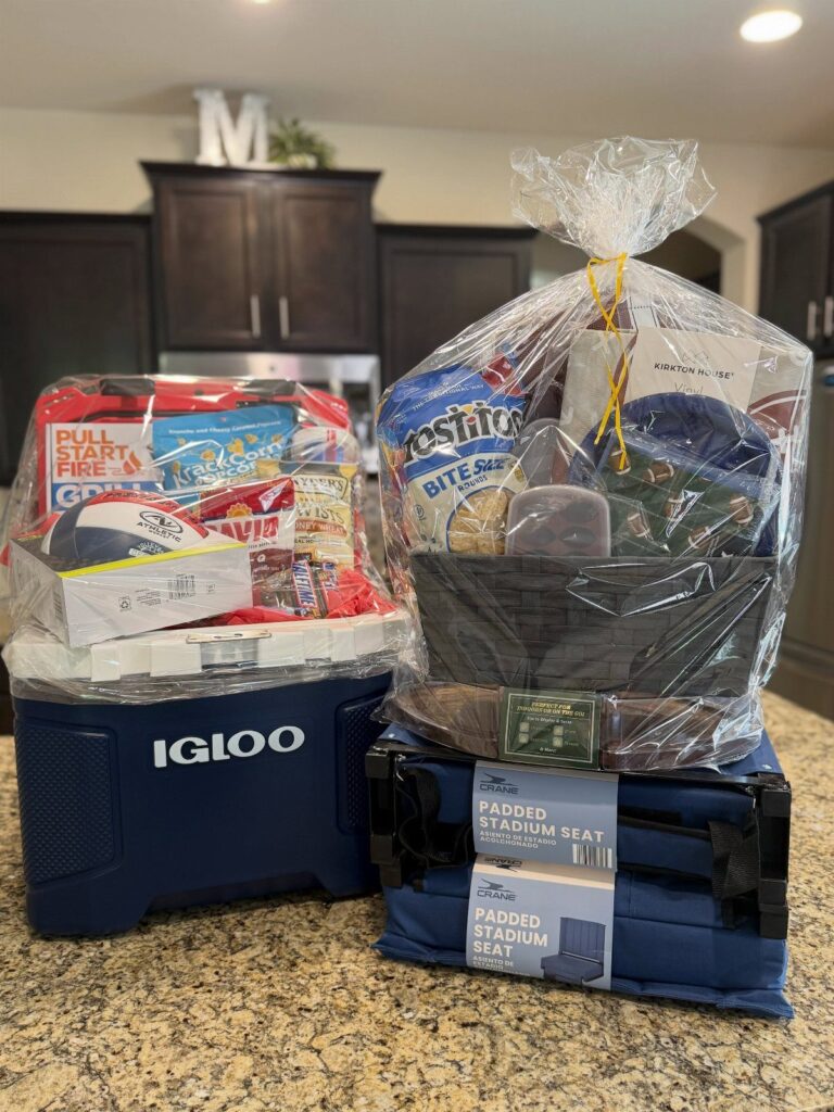 Blue Igloo cooler gift basket filled with snacks and outdoor gear.