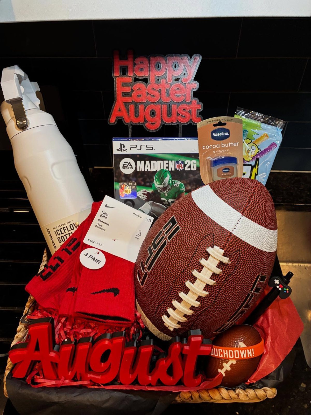 Easter basket for men containing a football, video game, and red socks.