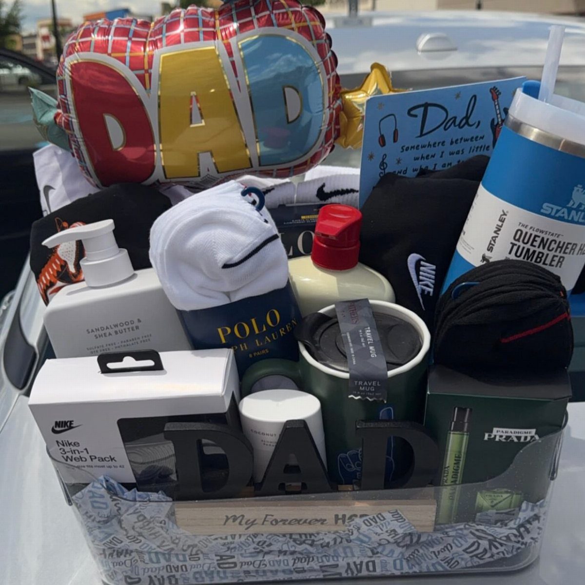 Gift basket for father containing a DAD balloon, Stanley tumbler, and grooming products.