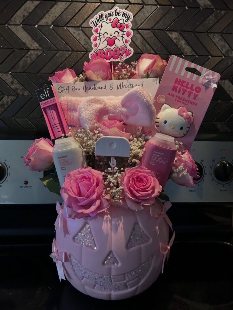 Pink jack-o'-lantern bucket filled with pink roses and Hello Kitty beauty products.