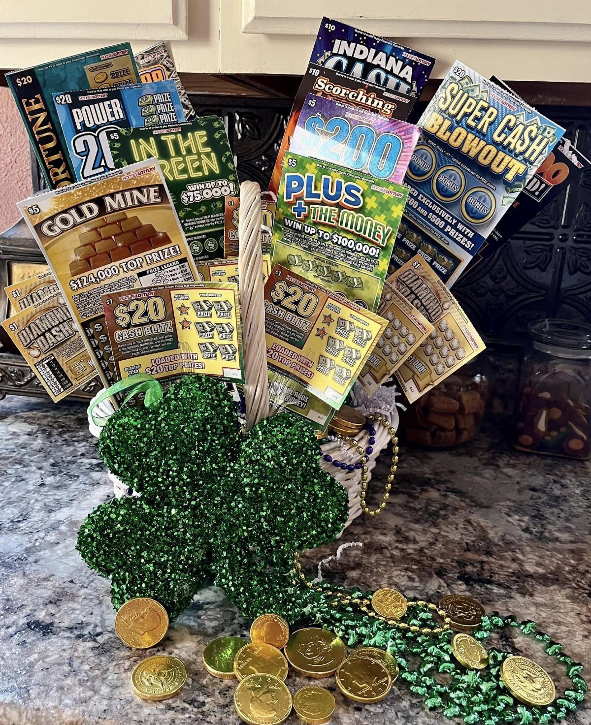 Lottery scratch-off tickets in a white basket decorated with a green glittery shamrock.