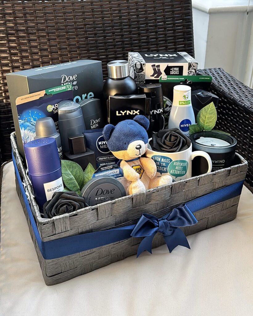 Men's grooming gift basket with toiletries, a blue teddy bear, and a black mug.
