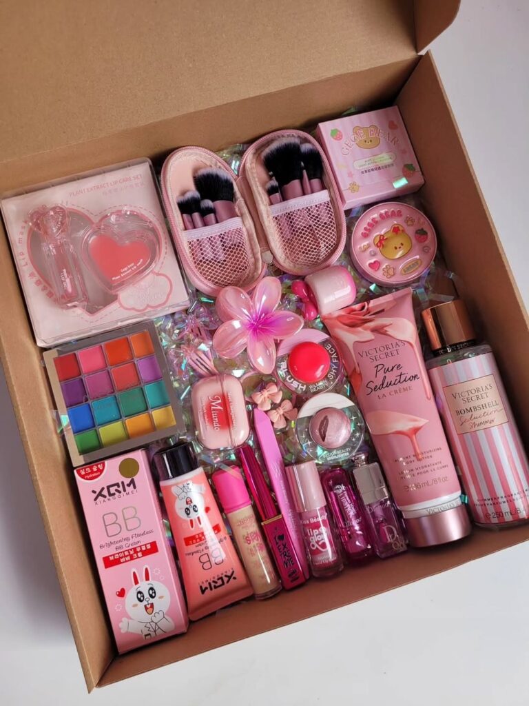 Beauty gift box filled with pink makeup, skincare products, and iridescent filler.