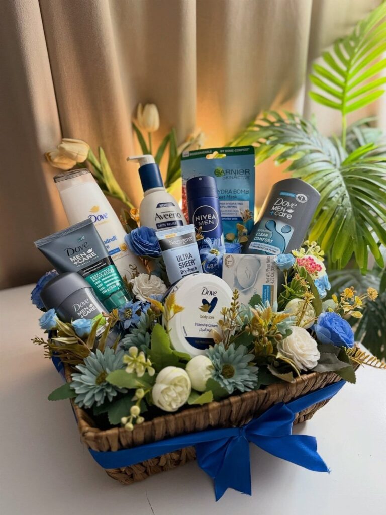 Skin care gift basket with lotions, creams, blue flowers, and a blue ribbon.